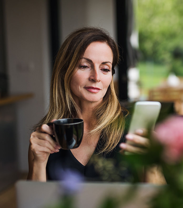 Lady at a coffee shop on her phone