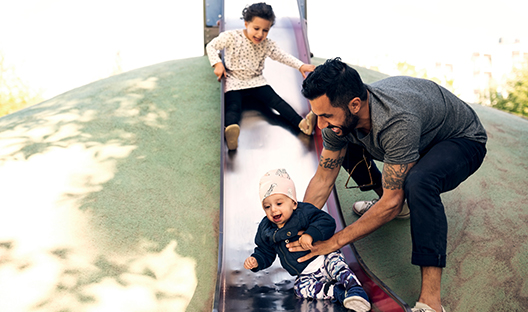 Family playing on a slide