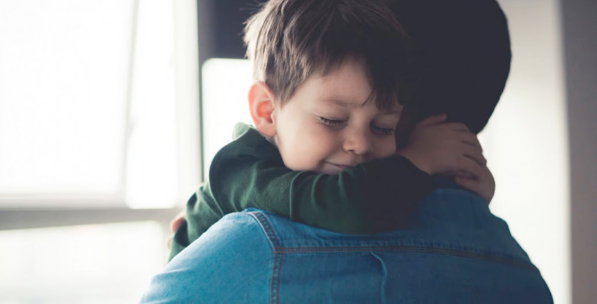 Young boy hugging his dad