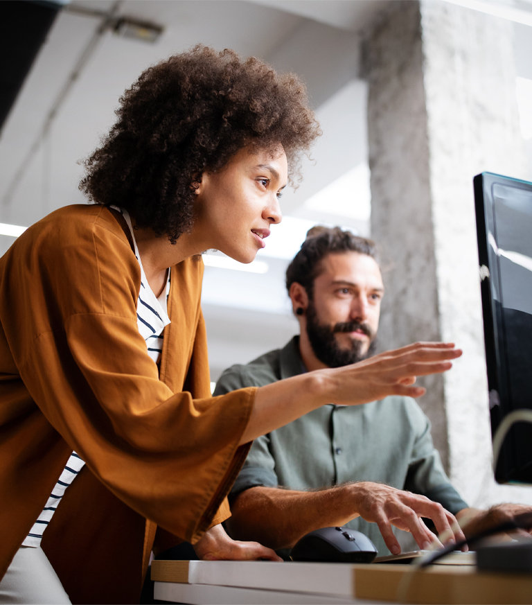 lady and man looking on computer screen