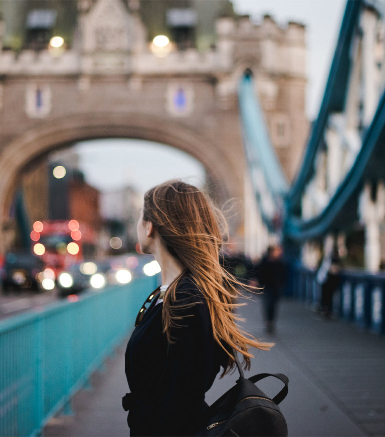 A non-resident woman stands on Tower Bridge in London