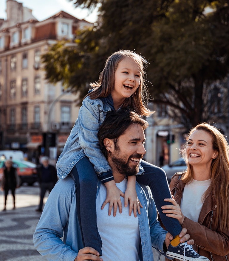Happy family outdoors smiling about their family banking and Private Bank Account