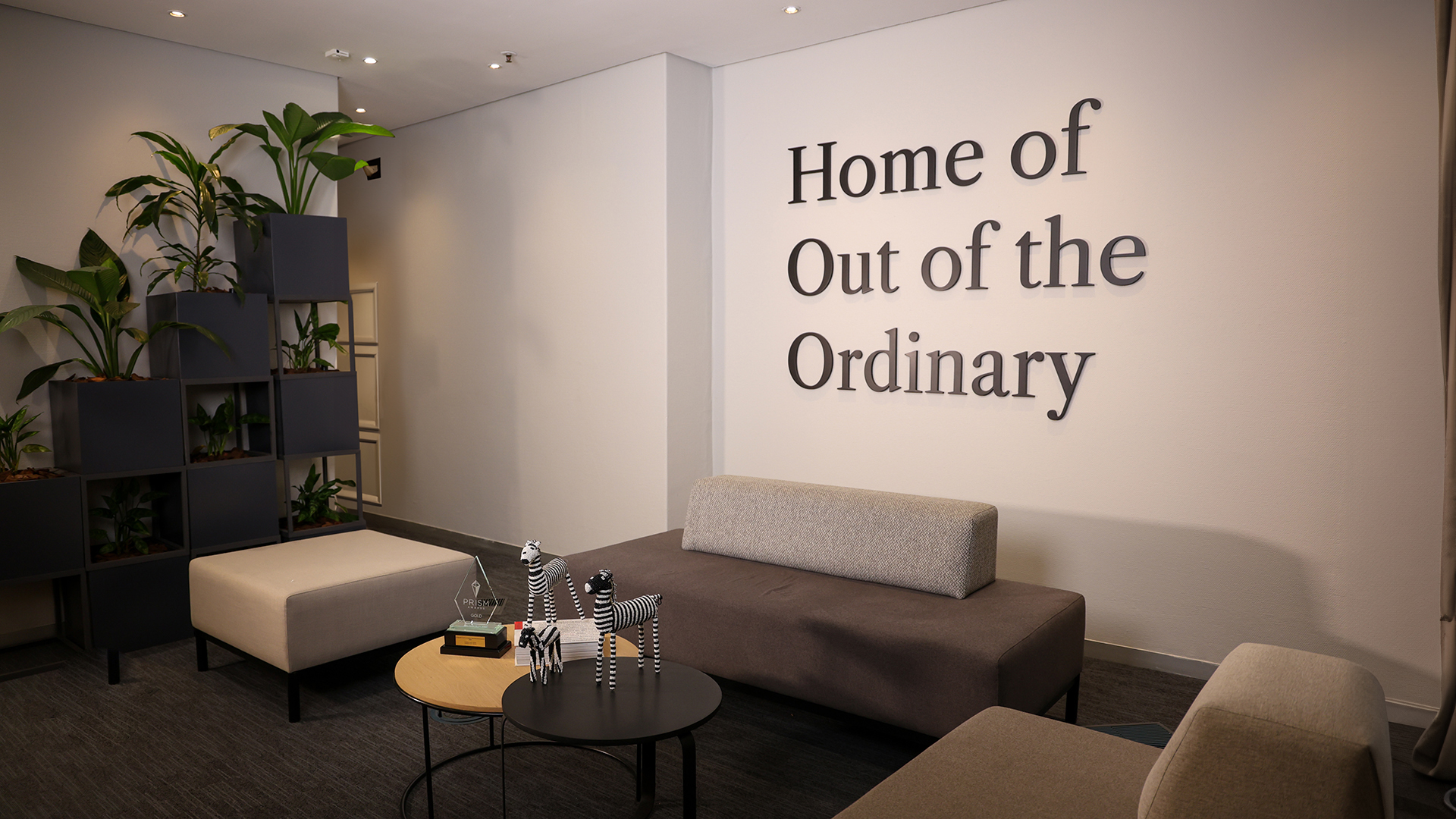 Home of Out of the Ordinary messaging on office wall