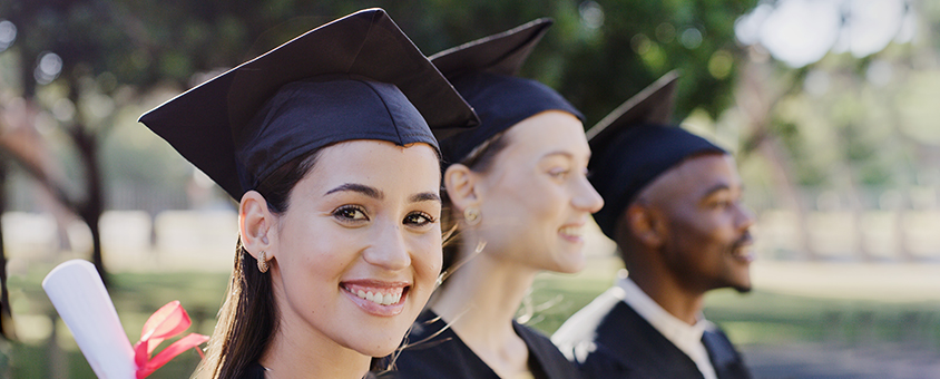 Young female graduate smiling at camera