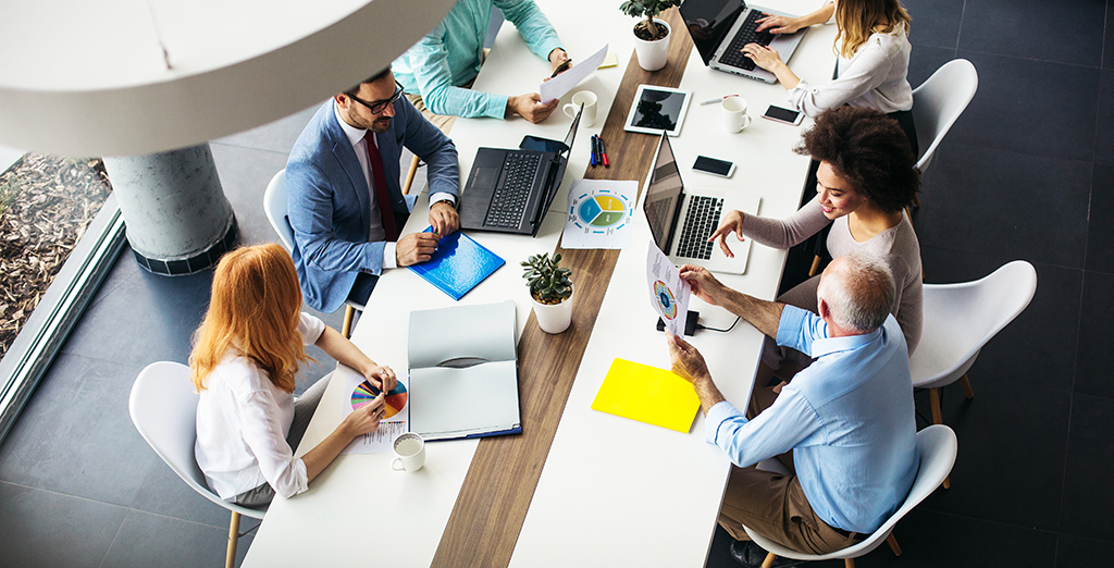 young entrepreneurs working together at a long desk