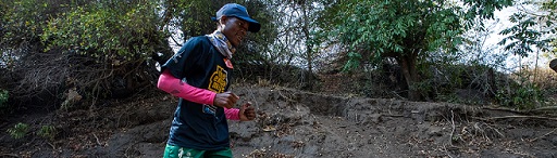 A runner navigating the tricky riverbed of the 21km trail run