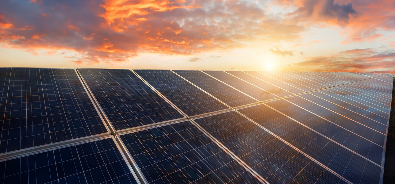 Sunset over a bank of solar panels