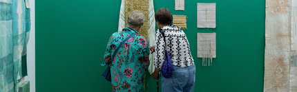 Friends studying a piece of art in great detail