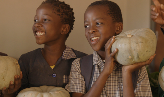 Children with pumpkins provided by Care for Wild's agricultural project