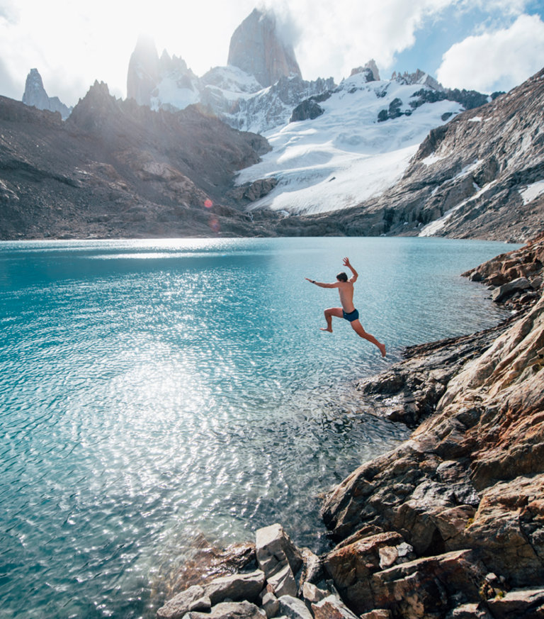 man jumping into lake