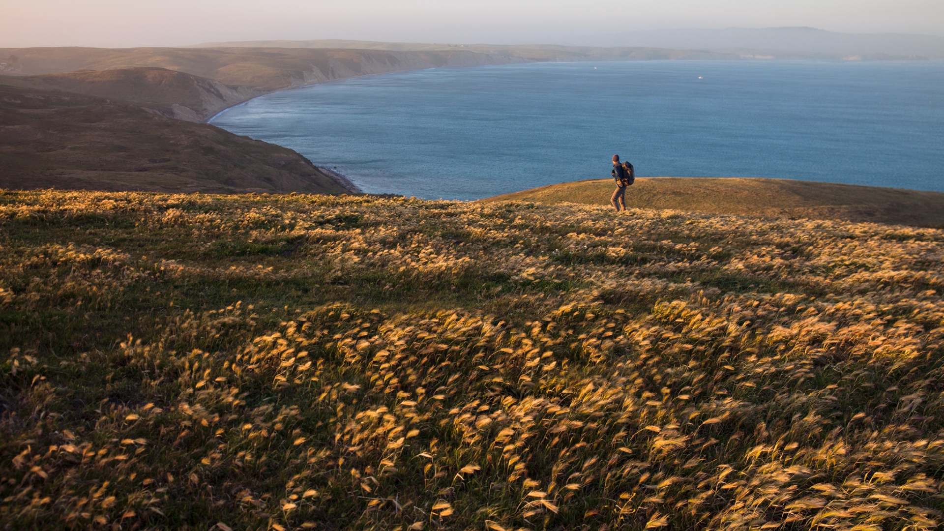 man taking a hike on a cliff