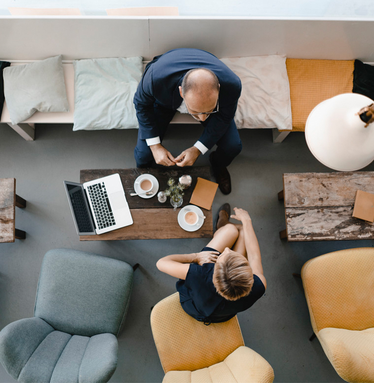 FX adviser chatting with client across table
