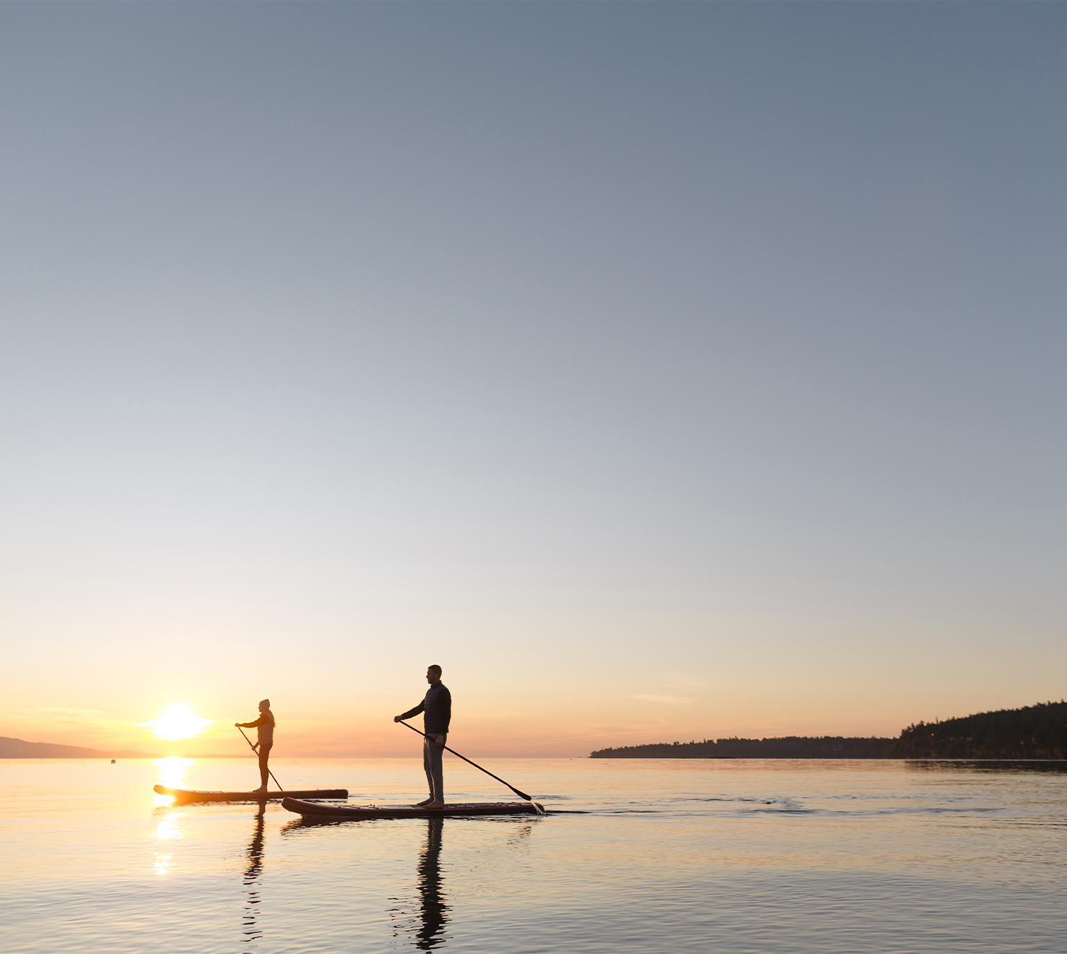 paddle boarders on a lake