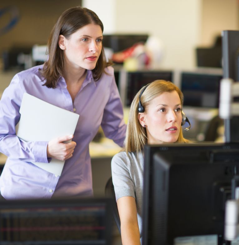 Two traders looking at dealing screens