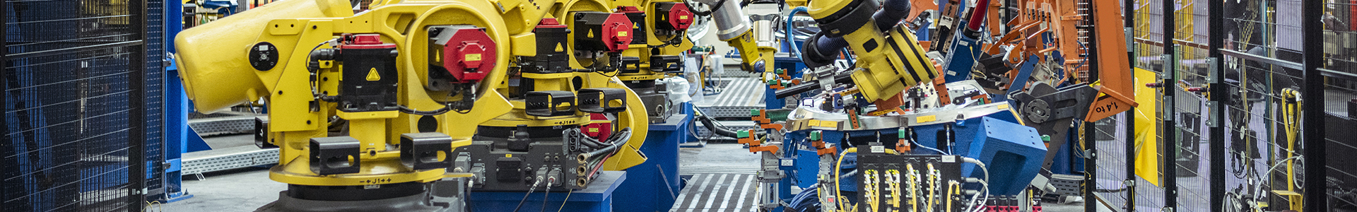 Robotic factory machines put together car parts