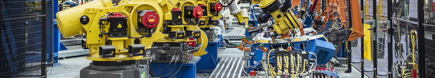 Robotic factory machines put together car parts