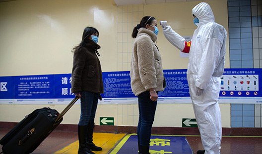 Two women wait to be analysed for symptoms