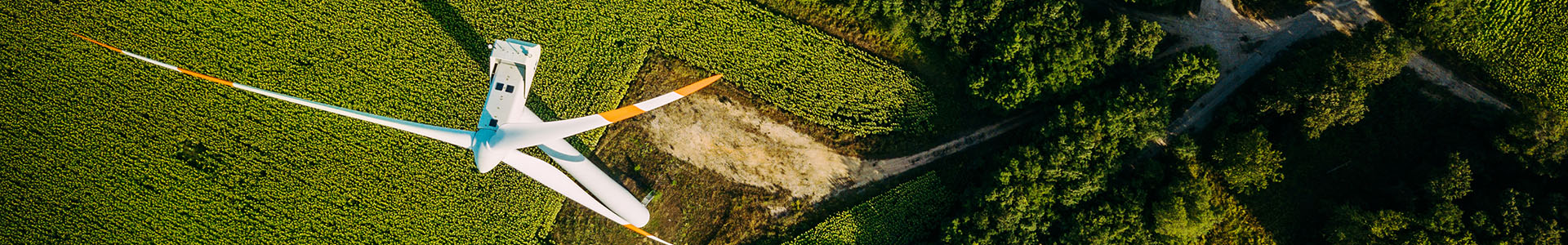 Aerial view of a wind turbine and cultivated fields