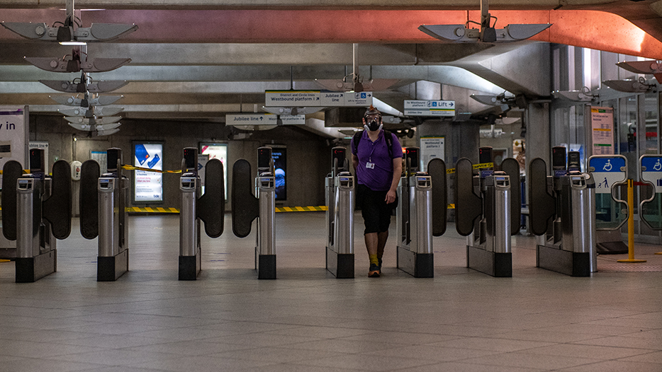 Man makes his way through the London underground ticket hall