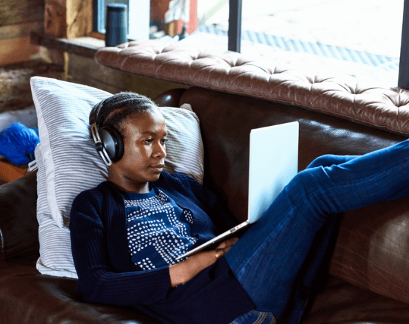 Lady lying on the sofa listening to music