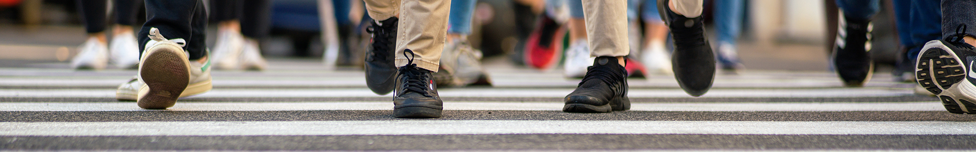 A crowd of people crossing a street