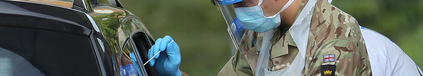 A member of the military wearing a protective face mask and screen