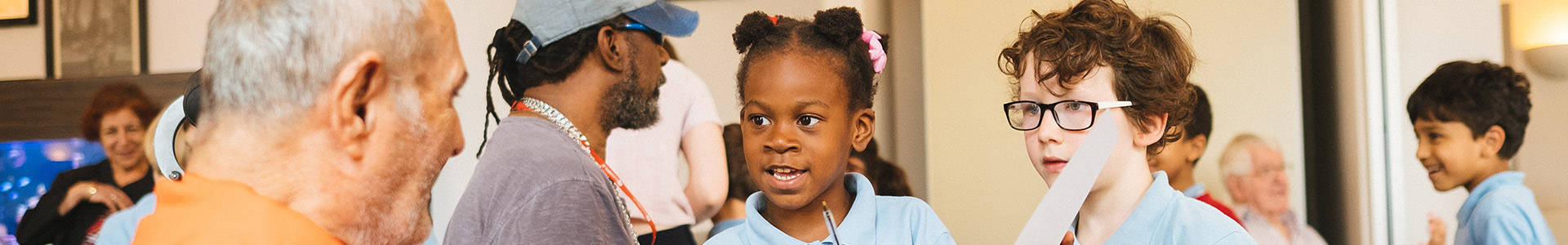 Primary school children visiting a retirement home to take part of educational activities and build links with senior members of their community.