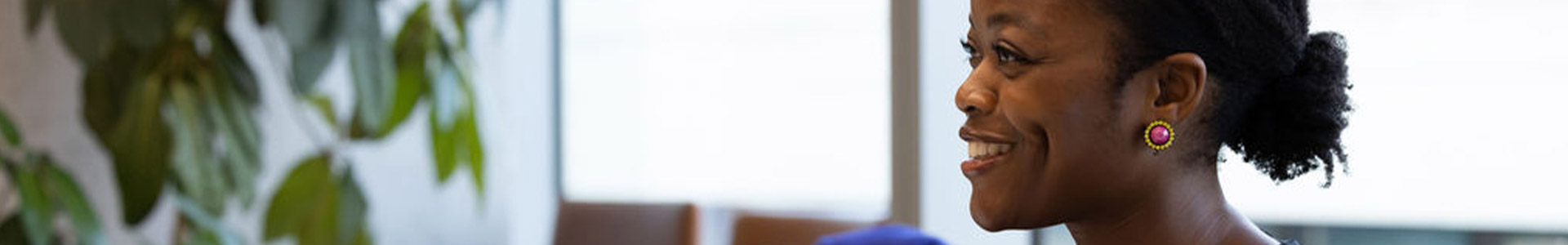 Female sat at meeting desk infront of a laptop screen