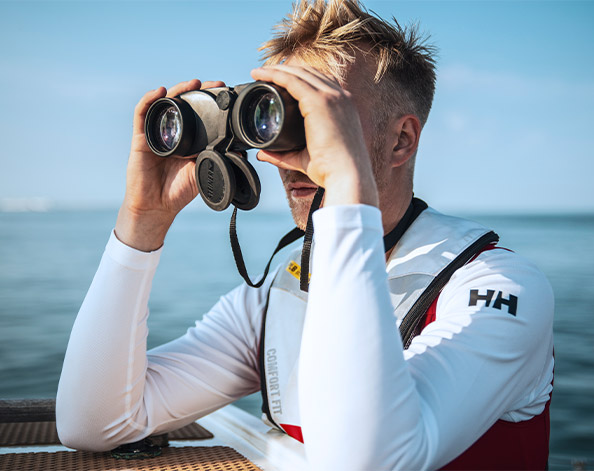 sea ranger looking through binoculars