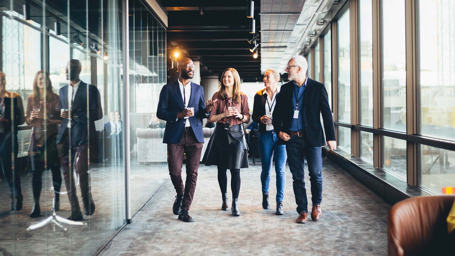 Group of 4 colleagues walking