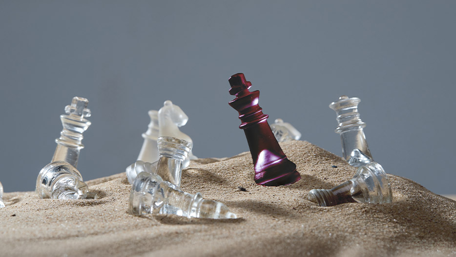Chess pieces in sand