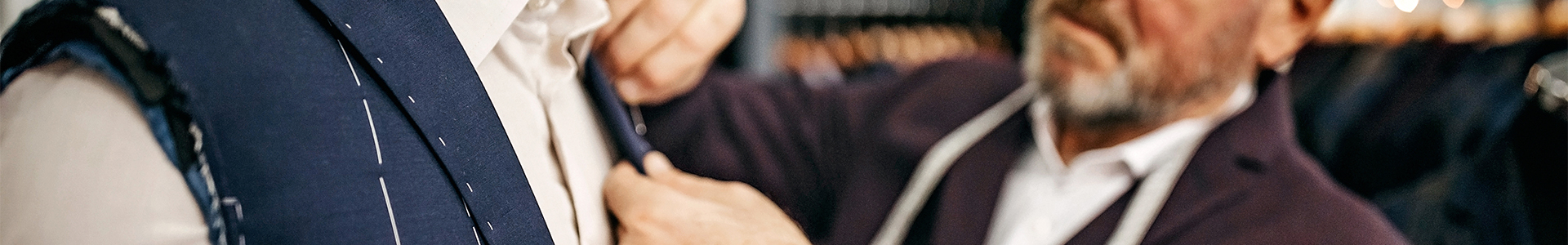 tailor fitting a male with a new suit