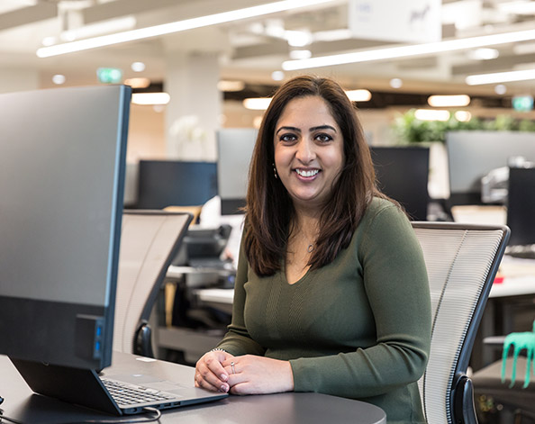 Woman sitting at a desktop computer