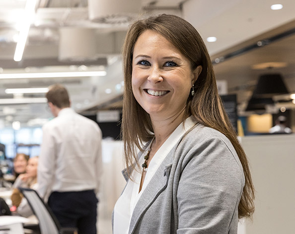 Woman standing in front of a desk at work