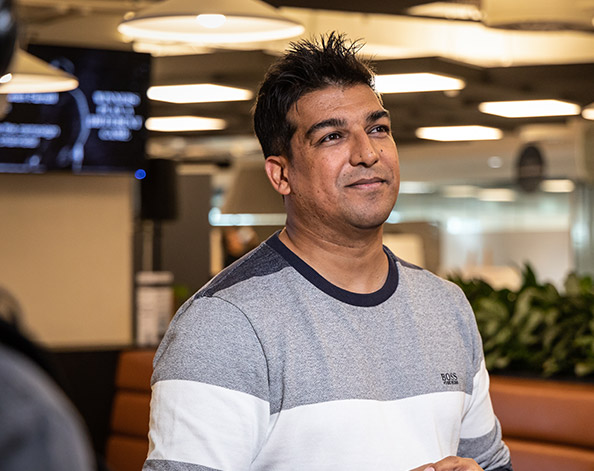 Man in a striped jumper in a collaborative office