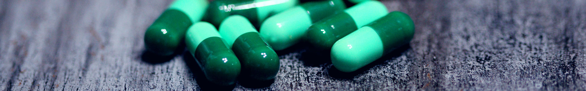 Green pills on table