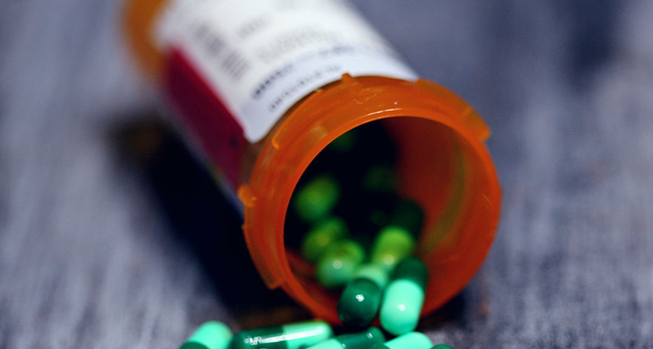 Green pills scattered on table