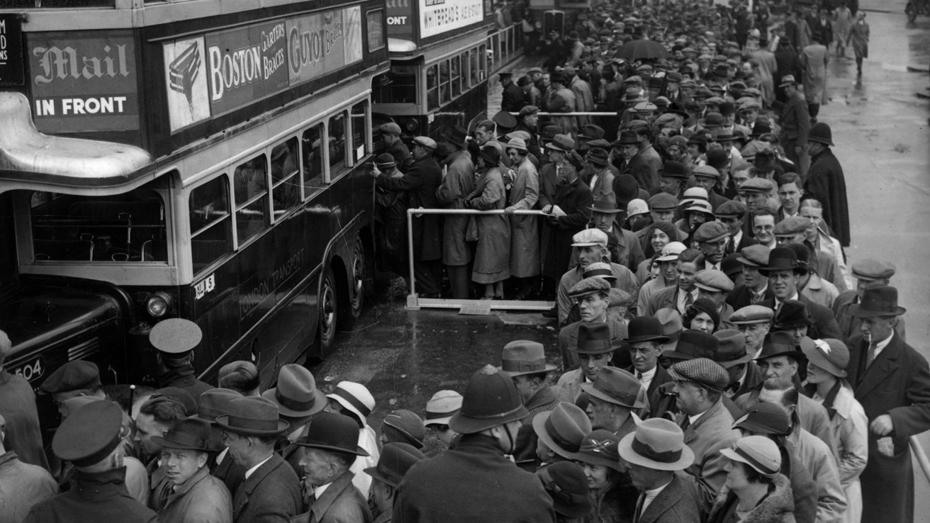 Crowds at Morden wait to board buses for the Epsom Derby in 1935