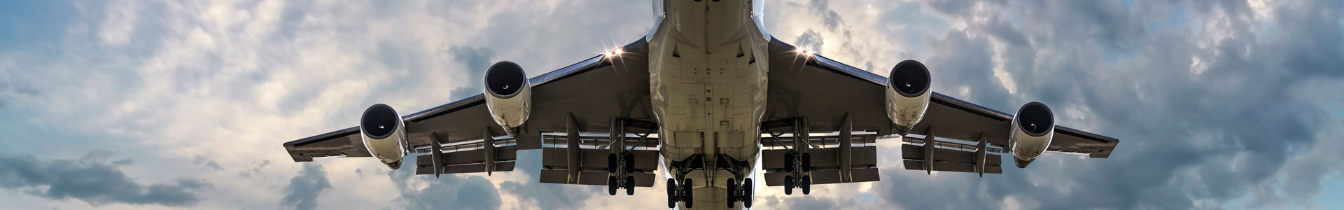 A plane taking off in the evening with runway lights
