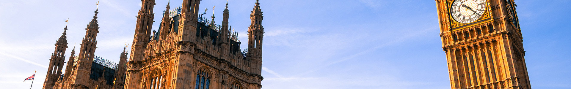 Close up of Big Ben and houses of parliment towers with blue skys behind