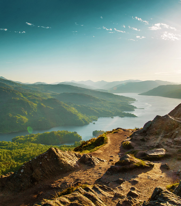 Looking down at a loch with mountains behind it