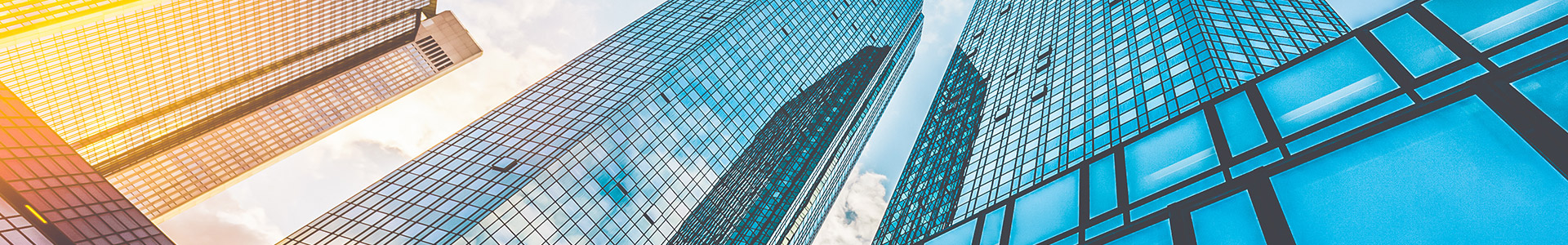 modern office towers with sunlight hitting one of the towers