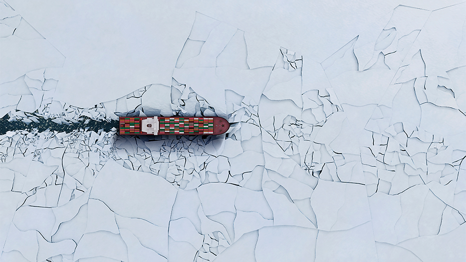 Cargo ship breaking through ice