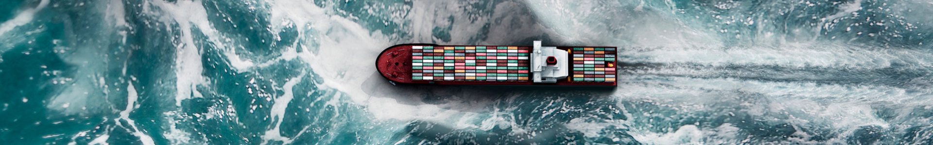 View from above of a cargo ship going through rough seas