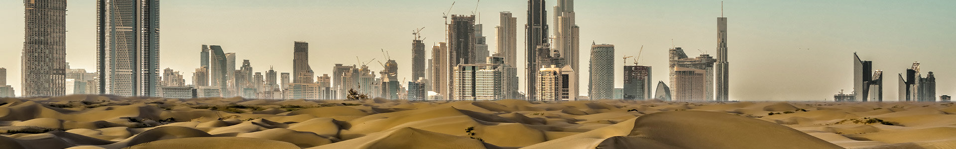 Dubai skyline with desert sand in foreground