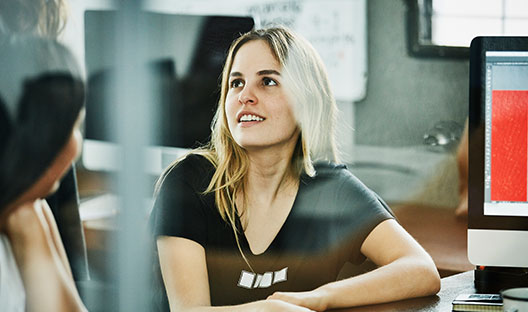 Woman at work speaking to colleague