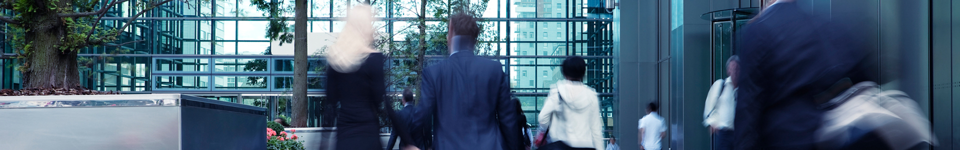 Business people walking around corporate office lobby