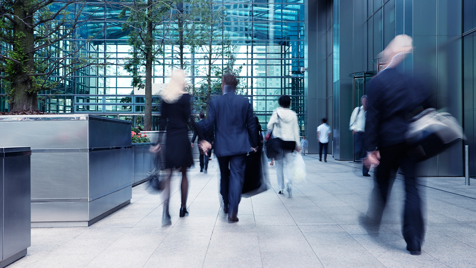 Business people walking around corporate office lobby