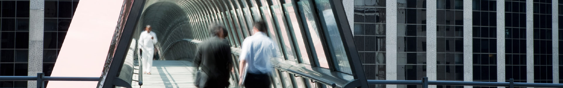 Business people walking through a tunnel outside office building