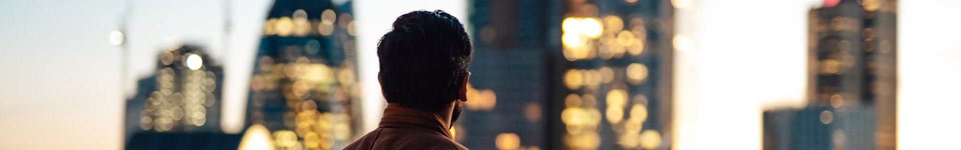 Businessman looking out towards the London city skyline
